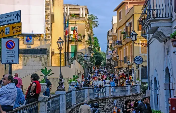TAORMINA, ITALY - SEPTEMBER 28, 2009: Tourists walking in Taormina, Sicily.